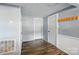 Hallway with wood flooring, neutral paint, and access to other rooms at 2903 Price Rushing Rd, Monroe, NC 28110