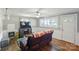 Cozy living room with wood floors, a ceiling fan, and natural light at 2903 Price Rushing Rd, Monroe, NC 28110