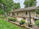 Landscaped backyard with patio and a dining set at 2911 Butter Churn Ln, Matthews, NC 28105