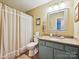 Bathroom featuring a vanity with a granite countertop and a shower with a curtain at 2911 Butter Churn Ln, Matthews, NC 28105