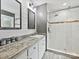 Modern bathroom with granite countertop vanity, dual mirrors and a glass-enclosed shower at 2911 Butter Churn Ln, Matthews, NC 28105