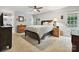 Inviting bedroom with a ceiling fan, neutral walls, and carpeted floors at 2911 Butter Churn Ln, Matthews, NC 28105