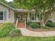 Inviting front entrance with brick steps, a white railing, and lush greenery at 2911 Butter Churn Ln, Matthews, NC 28105