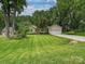 Beautiful single-story house showcasing a well-kept lawn and attractive landscaping at 2911 Butter Churn Ln, Matthews, NC 28105