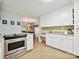 Bright eat-in kitchen with white cabinets and granite counters leading to a formal dining area at 2911 Butter Churn Ln, Matthews, NC 28105