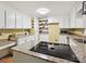 Well-lit kitchen with granite countertops, white cabinets, and stainless-steel microwave at 2911 Butter Churn Ln, Matthews, NC 28105