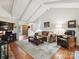 Comfortable living room featuring vaulted ceilings, hardwood floors, and a cozy seating area at 2911 Butter Churn Ln, Matthews, NC 28105