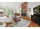 Cozy living room features a stone fireplace, hardwood floors, and French doors to the backyard at 2911 Butter Churn Ln, Matthews, NC 28105
