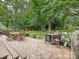 Outdoor patio featuring a dining area, grill, and lush greenery at 2911 Butter Churn Ln, Matthews, NC 28105
