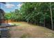 Wide backyard surrounded by large trees at 300 Dollar Cir, Charlotte, NC 28270