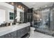 Modern bathroom featuring sleek black tiles, double vanity, and a glass-enclosed shower at 300 Dollar Cir, Charlotte, NC 28270