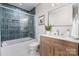 Bright bathroom equipped with stylish fixtures, a bathtub with glass door, and a wooden vanity at 300 Dollar Cir, Charlotte, NC 28270