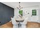 Elegant dining area with modern chandelier, sleek gray wall feature, and access to outdoor views at 300 Dollar Cir, Charlotte, NC 28270