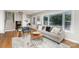 Cozy living room featuring a comfortable sofa, fireplace, and large bay window for natural light at 300 Dollar Cir, Charlotte, NC 28270