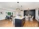 Open floor plan integrates the kitchen island, dining area with seating, and living room at 300 Dollar Cir, Charlotte, NC 28270