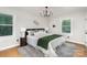 Serene primary bedroom with a plush bed, stylish lighting, and large windows for natural light at 300 Dollar Cir, Charlotte, NC 28270
