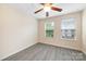 Bedroom featuring a ceiling fan and two windows with neighborhood views at 3039 Potomac River Pkwy, Charlotte, NC 28217