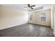Spacious bedroom with a tray ceiling, ceiling fan, and two windows at 3039 Potomac River Pkwy, Charlotte, NC 28217