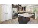 Stylish kitchen features stainless steel appliances, dark cabinetry, and a granite-topped center island at 3039 Potomac River Pkwy, Charlotte, NC 28217