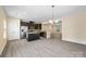 Modern kitchen with black cabinets, granite countertops, and stainless steel appliances at 3039 Potomac River Pkwy, Charlotte, NC 28217
