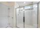 Bathroom featuring a shower with glass doors and white tile at 3039 Potomac River Pkwy, Charlotte, NC 28217