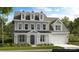 Charming two-story home featuring a modern architectural design and well-manicured landscaping at 3058 Tramore Dr, Harrisburg, NC 28075