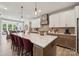 Modern kitchen island with white countertops, barstool seating, pendant lighting, and stainless steel appliances at 3058 Tramore Dr, Harrisburg, NC 28075