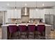 Contemporary kitchen with a large island featuring barstool seating, pendant lighting, and modern finishes at 3058 Tramore Dr, Harrisburg, NC 28075