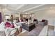 The spacious living room connects to the kitchen and features a large decorative rug and accent pillows at 3058 Tramore Dr, Harrisburg, NC 28075