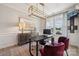 Contemporary office featuring modern lighting, desk, large painting, and comfortable seating at 3058 Tramore Dr, Harrisburg, NC 28075