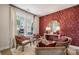 Cozy sitting room with comfortable chairs, patterned wallpaper, table, and ample natural light at 3058 Tramore Dr, Harrisburg, NC 28075