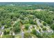 An aerial view of the property showcases its location among lush greenery and nearby homes with a pond view at 3424 Autumn Dr, Gastonia, NC 28056