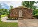 Brick home featuring a quaint backyard patio area with fresh landscaping and a private setting at 3424 Autumn Dr, Gastonia, NC 28056