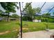 The backyard features a grassy lawn, mature trees, and sheds with a patio space and outdoor lighting at 3424 Autumn Dr, Gastonia, NC 28056