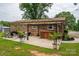 Backyard view of a brick house with a concrete patio, grill, a bar and lush green grass at 3424 Autumn Dr, Gastonia, NC 28056