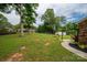 Spacious backyard featuring a manicured lawn and mature shade trees at 3424 Autumn Dr, Gastonia, NC 28056