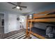 Bedroom with wood-look floors and bunk beds, adjacent bathroom visible at 3424 Autumn Dr, Gastonia, NC 28056