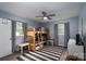 Bedroom featuring bunkbeds, striped rug, ceiling fan, and gray curtains at 3424 Autumn Dr, Gastonia, NC 28056