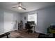 Bedroom with work station, wood-look flooring, ceiling fan, and natural light at 3424 Autumn Dr, Gastonia, NC 28056