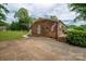 Brick home with a large lawn, enhanced by beautiful landscaping, offering a serene setting at 3424 Autumn Dr, Gastonia, NC 28056