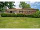 Inviting brick home featuring a well-kept lawn and neatly trimmed bushes, providing pleasant curb appeal at 3424 Autumn Dr, Gastonia, NC 28056