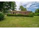 Charming brick ranch home with a well-manicured lawn and mature trees at 3424 Autumn Dr, Gastonia, NC 28056