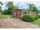 Brick home with manicured lawn and inviting curb appeal, complemented by an American flag at 3424 Autumn Dr, Gastonia, NC 28056