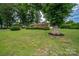 Well-maintained brick home with mature trees and a spacious front lawn, perfect for outdoor activities at 3424 Autumn Dr, Gastonia, NC 28056