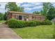 Charming brick home with a well-manicured lawn and lush landscaping, creating an inviting curb appeal at 3424 Autumn Dr, Gastonia, NC 28056