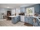 Eat-in kitchen featuring blue cabinets, tiled floors, and open access to dining area at 3424 Autumn Dr, Gastonia, NC 28056