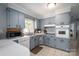 Bright kitchen featuring painted cabinets, tiled floors, and ample countertop space at 3424 Autumn Dr, Gastonia, NC 28056