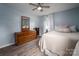 Bedroom with wood-look floors, dresser, and natural light from window at 3424 Autumn Dr, Gastonia, NC 28056