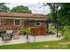 Outdoor patio features a gazebo, a wooden bar with barstools, and outdoor furniture, perfect for entertaining at 3424 Autumn Dr, Gastonia, NC 28056