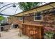 View of patio with a wooden bar, barstools, grill and an outdoor table with chairs at 3424 Autumn Dr, Gastonia, NC 28056
